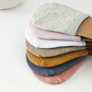 Detailed macro view of multi-color cotton invisible half-palm socks in various pastel shades