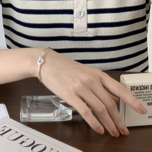 Minimalist S925 sterling silver interlocking knot cuff bracelet for elegant women