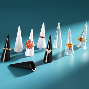 Cone-shaped ring display stands in black, white and clear plastic on blue background