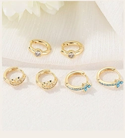 Detailed macro view of 14k gold plated earrings with blue crystals and sparkling rhinestones