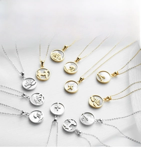 Detailed close-up of various stainless steel shell pendants in gold and silver finishes
