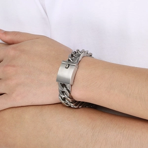Close-up of 18mm wide brushed silver Cuban chain bracelet on male wrist