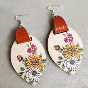 Bohemian teardrop wood earrings with sunflower and daisy patterns on grey background