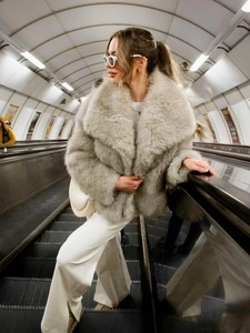 Detail of plush faux fur texture and large lapel collar on a chic short winter coat