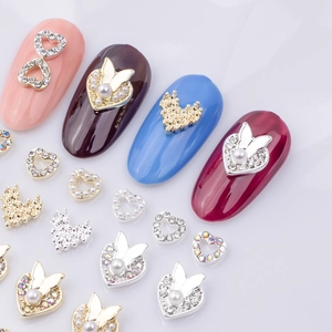 Exquisite 3D heart and butterfly nail charms with rhinestones on colored manicured nails