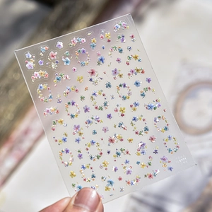 Close-up of relief nail stickers featuring colorful dried flowers with shell light effect
