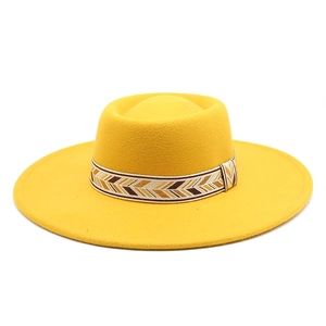 Detail of yellow wool fedora hat featuring a patterned woven geometric decorative band