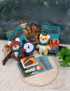 Adventure-themed plush dog squeaky toys including bear and compass shapes on woven mat