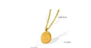 Close-up of gold oval pendant necklace engraved with 'you are adorable' text