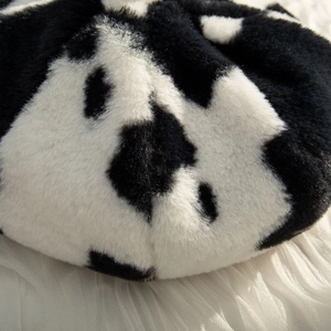 Plush cow print beret hat for women with soft faux fur texture and black white pattern