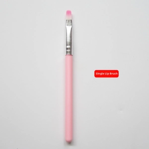 Detail view of round silicone lip brush with pink handle and silver ferrule for makeup