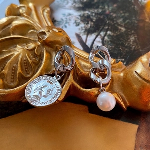 Elegant asymmetrical silver drop earrings featuring a vintage coin and white pearl design