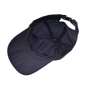 Macro shot of breathable laser-cut mesh and quick-dry fabric on the black sports cap