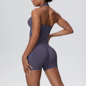 Two-piece dark purple seamless knitted yoga set with halter top and high-waist lifting shorts