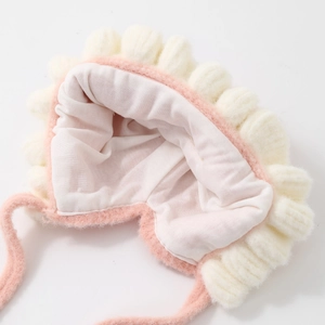 Detail view of pink baby knit hat showing soft skin-friendly lining and lace trim