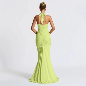 Detail of the backless halter design and ruching on a lime green mermaid dress