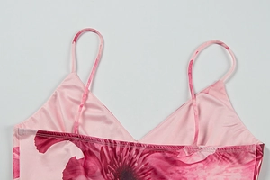 Detail of V-neckline and thin straps on pink floral satin slip dress for women
