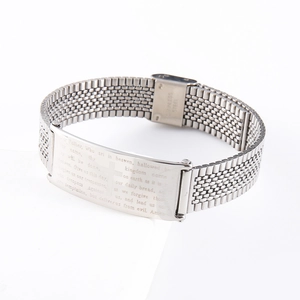 Close-up of silver stainless steel mesh bracelet with Lord's Prayer engraved plaque