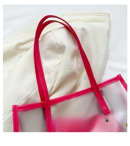 Detail of rose red PVC tote handle with reinforced metal rivets and stitching