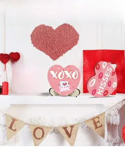 Three Valentine heart-shaped wooden plaques with Hugs, Xoxo, Kisses text and stands
