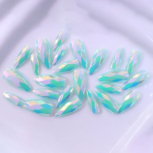 Detailed close-up of holographic long almond fake nails with geometric diamond facets