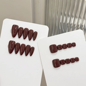 Glossy burgundy almond press-on nail set for fingers and toes on white background
