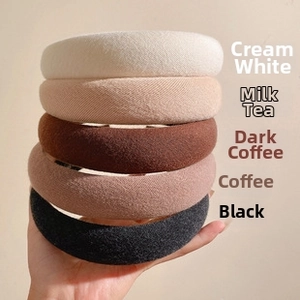 Stack of thick sponge headbands in milk white, brown, and black knitted fabric texture
