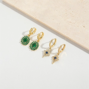 Vintage gold drop earrings with emerald green and starburst blue gemstones