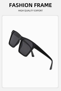 Detailed close-up of fashion sunglasses with oversized black frames and dark grey lenses