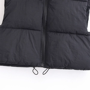 Quilted black puffer vest featuring a durable resin zipper and adjustable hem drawstring