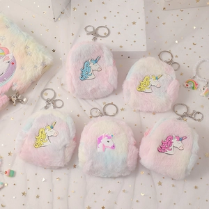 Detailed view of rainbow plush unicorn coin purses with silver metal lobster clasps