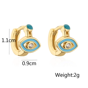 Detail of 18K gold-plated mini hoops with blue enamel evil eye and zircon inlay