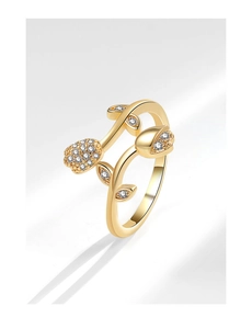 Macro shot of gold tulip ring with sparkling zircon stones and leaf texture details