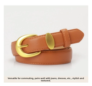 Detail of caramel leather belt with a matte gold oval buckle and fine stitching
