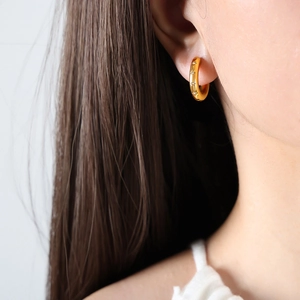 Elegant 18K gold plated C-shaped star zircon hoop earrings on model ear view