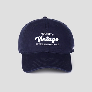 Close-up of white 3D embroidery on navy cotton twill vintage baseball cap