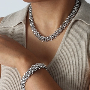 Silver multi-row chunky chain necklace and bracelet jewelry set for women worn by model