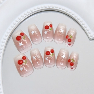 Pink cat eye press-on nails with glitter, cherry designs and white stars for women