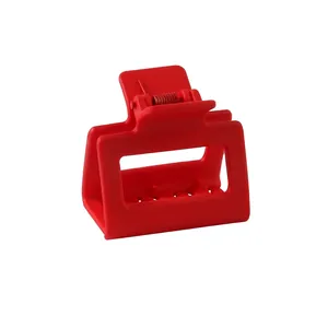 Macro detail of red matte square hair claw clip with cutout design and spring mechanism