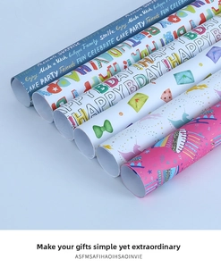Macro detail of six birthday gift wrapping paper rolls featuring colorful rainbow prints