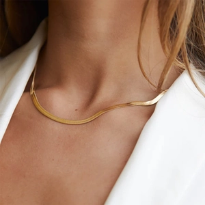 Minimalist 18K gold plated herringbone snake chain necklace worn by a fashion model