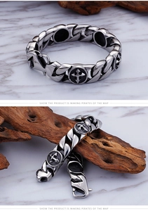 Macro detail of men's stainless steel curb chain bracelet with embossed cross star motifs