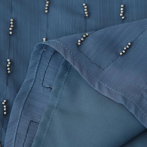 Blue-grey pleated camisole top with beaded shoulder straps and textured vertical fabric