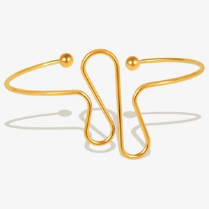 Detail of 18k gold plated stainless steel open bangle with wave design and round beads