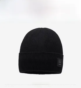 Close-up of black ribbed knit beanie featuring premium texture and square side patch detail
