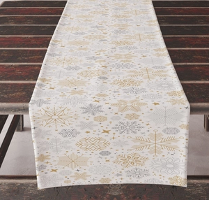Close-up of woven Christmas table runner with gold and silver snowflake patterns