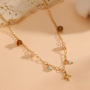 18K gold plated necklace with colorful beads and a golden star pendant on stone background