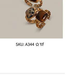 Close-up of gold chain rings with square leopard stone and tiger eye in vintage luxury style