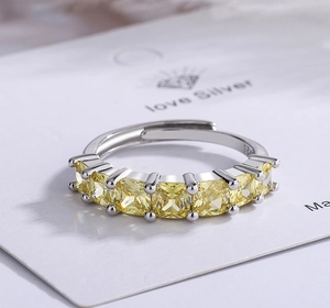 Macro shot of S925 sterling silver ring with seven square-cut yellow cubic zirconia stones
