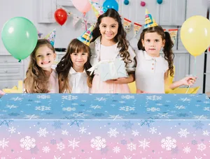 Detail of pink and blue gradient party tablecloth with festive white snowflake patterns